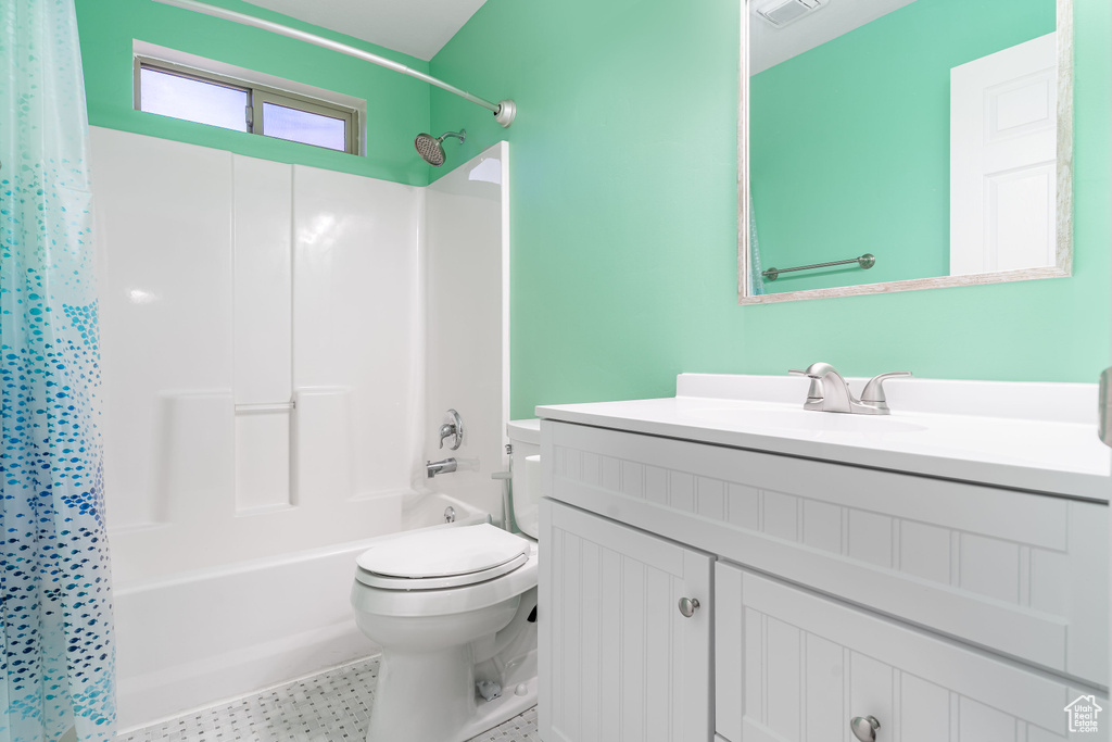 Full bath featuring vanity and shower / bathtub combination with curtain