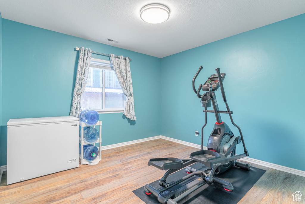Exercise room with wood finished floors