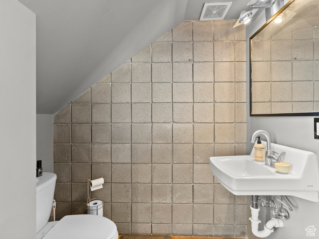 Bathroom featuring tile walls