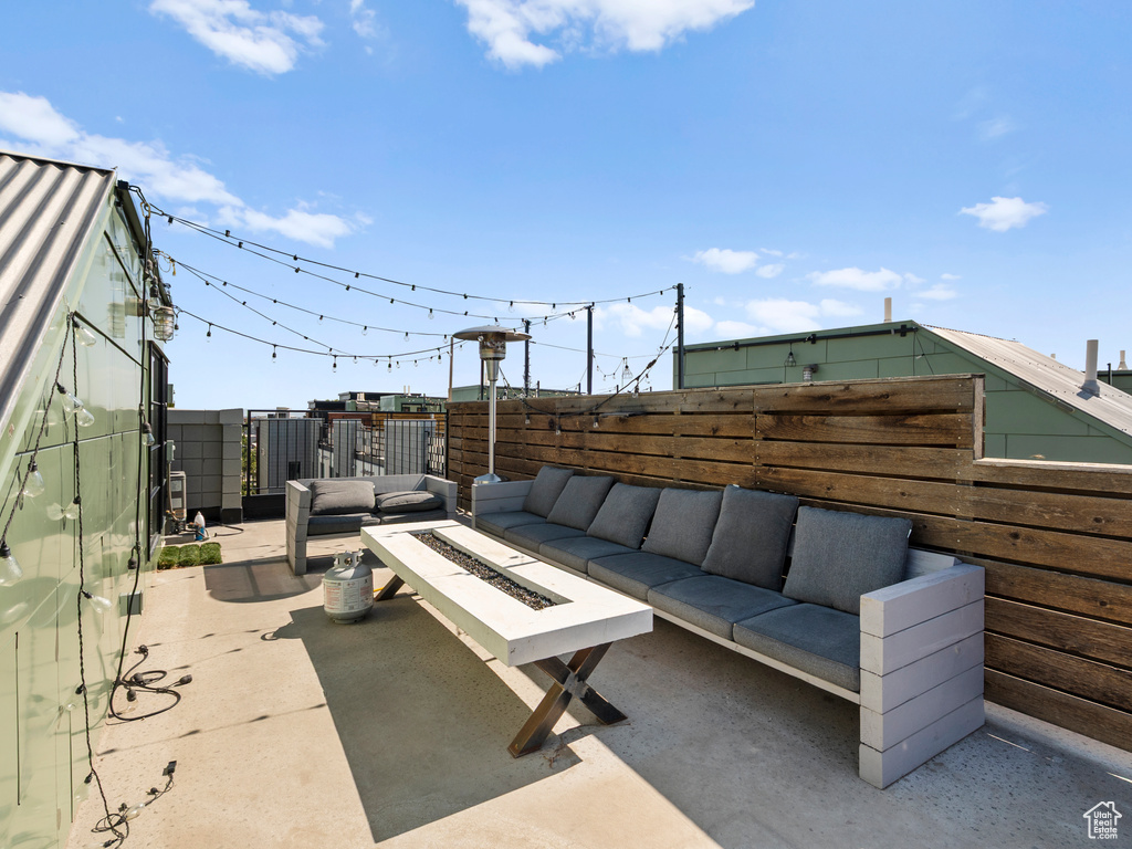 Fenced backyard with an outdoor living space with a fire pit and a patio