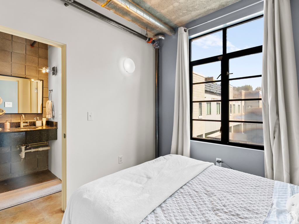 Bedroom with ensuite bath and concrete floors