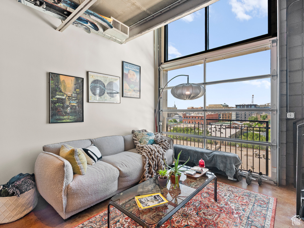 Living area with a high ceiling and finished concrete floors