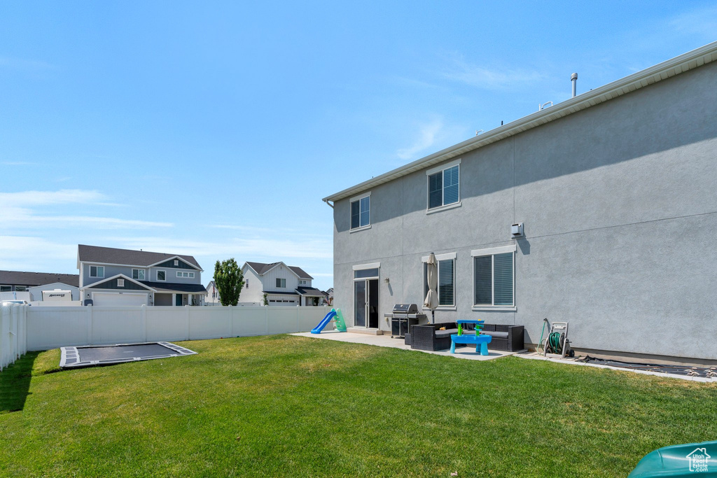 Fenced backyard featuring an outdoor hangout area and a patio area
