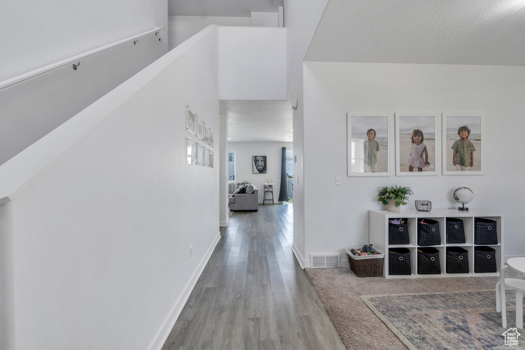 Hall featuring wood finished floors and baseboards
