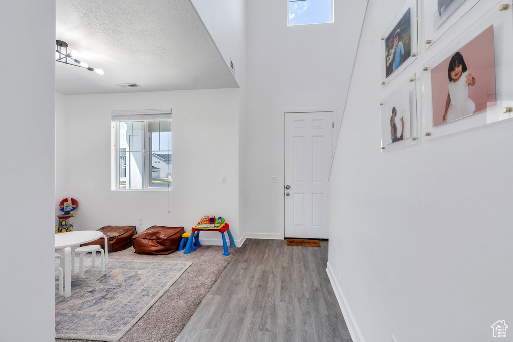 Entryway with wood finished floors and a textured ceiling