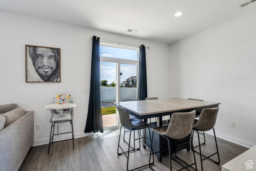 Dining room featuring wood finished floors and recessed lighting