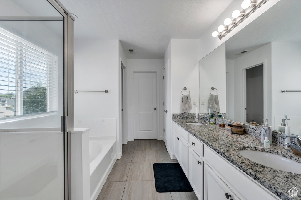Full bath with double vanity and a bath