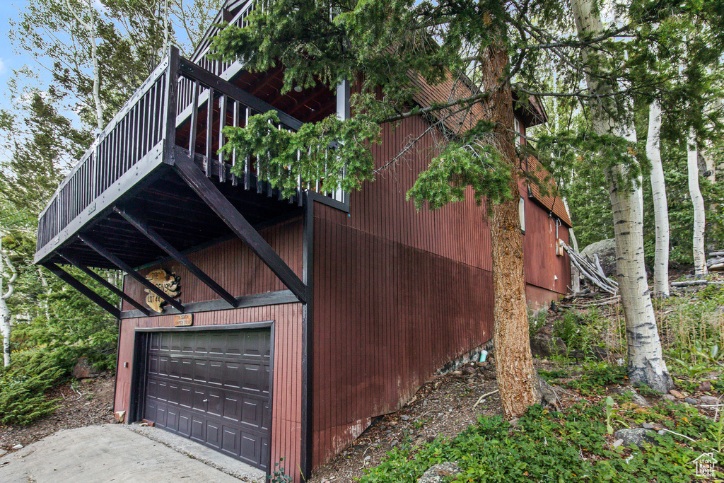 View of home's exterior featuring a wooden deck and a garage