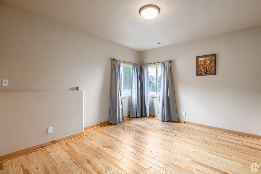 Empty room featuring light wood-type flooring and baseboards