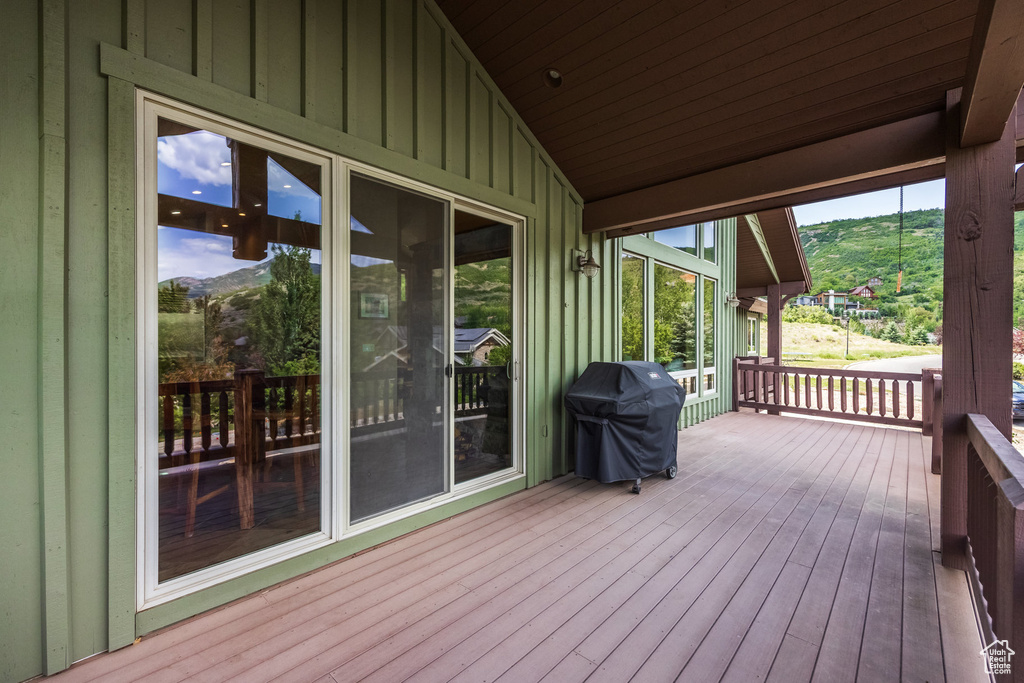 Wooden deck with area for grilling and a mountain view