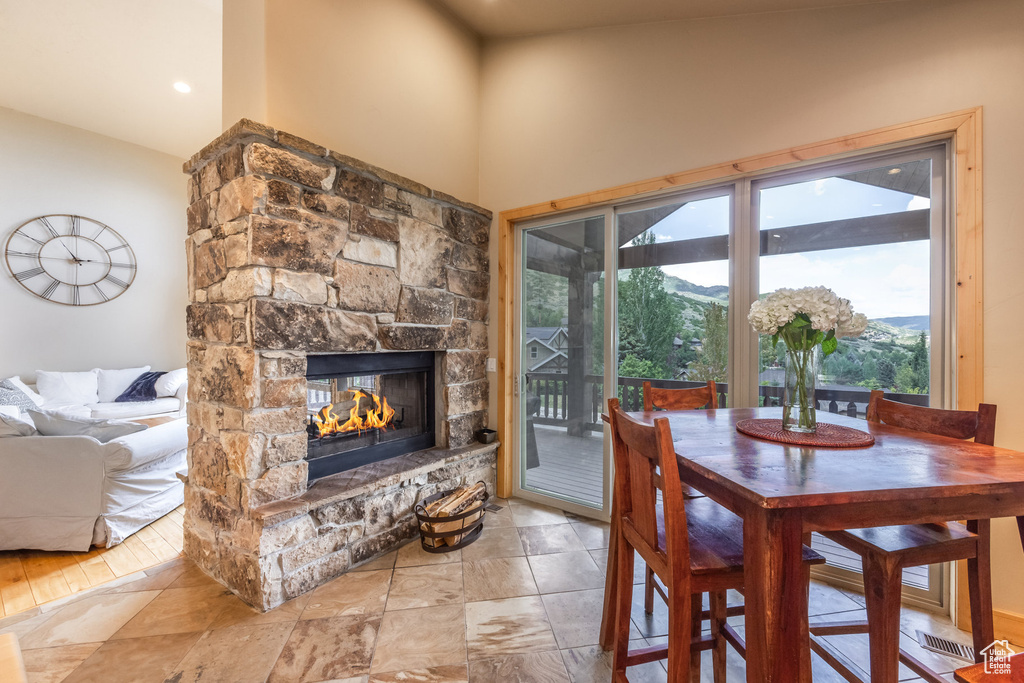 Dining room with a fireplace and high vaulted ceiling