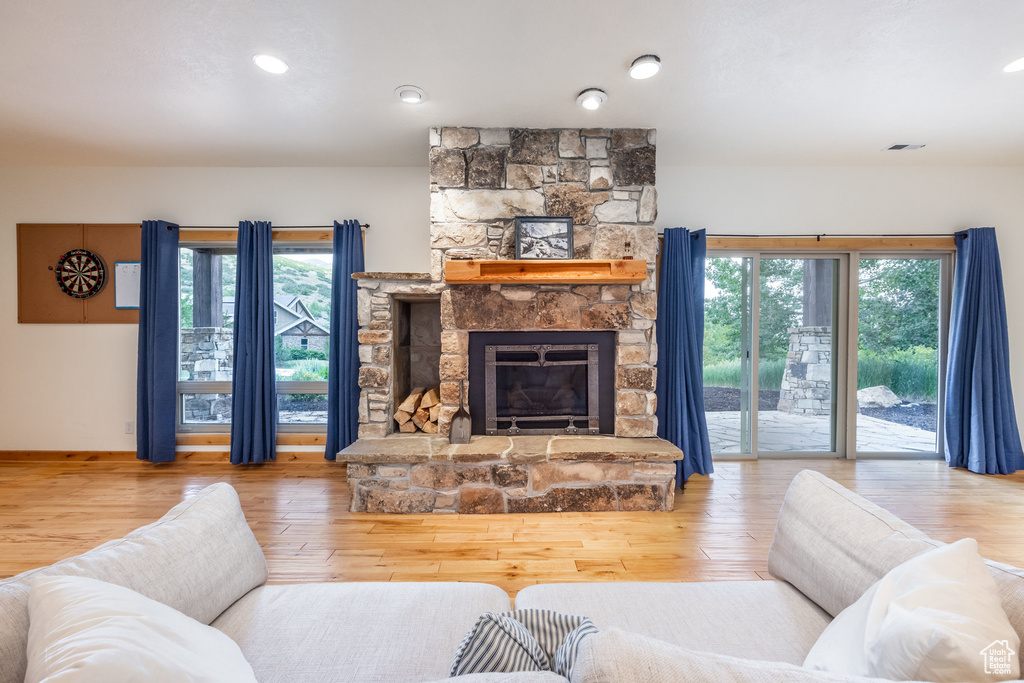 Living room with hardwood / wood-style floors, a fireplace, healthy amount of natural light, and recessed lighting