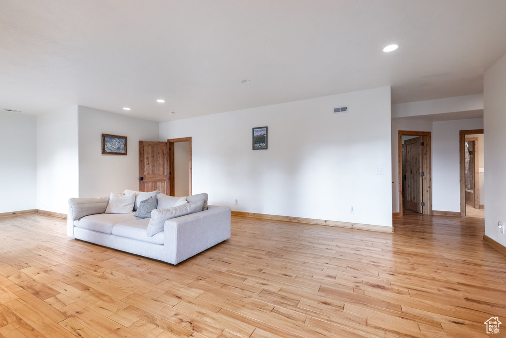Living area featuring wood finished floors and recessed lighting