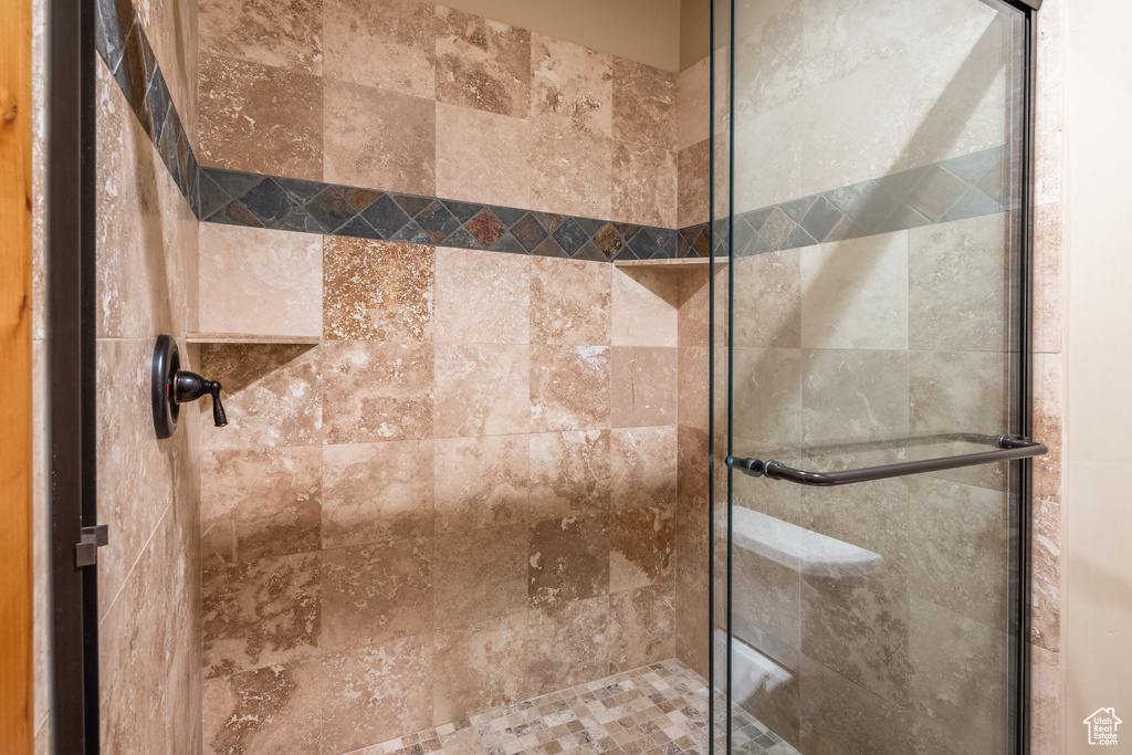Full bath featuring a shower stall