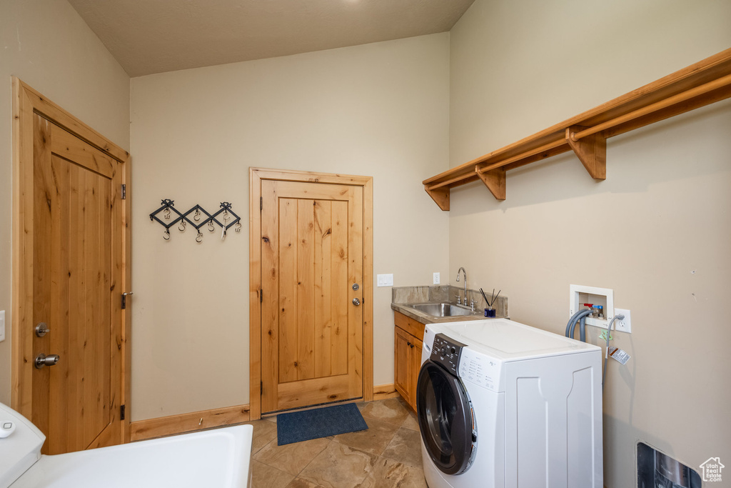 Washroom with cabinet space and washer hookup