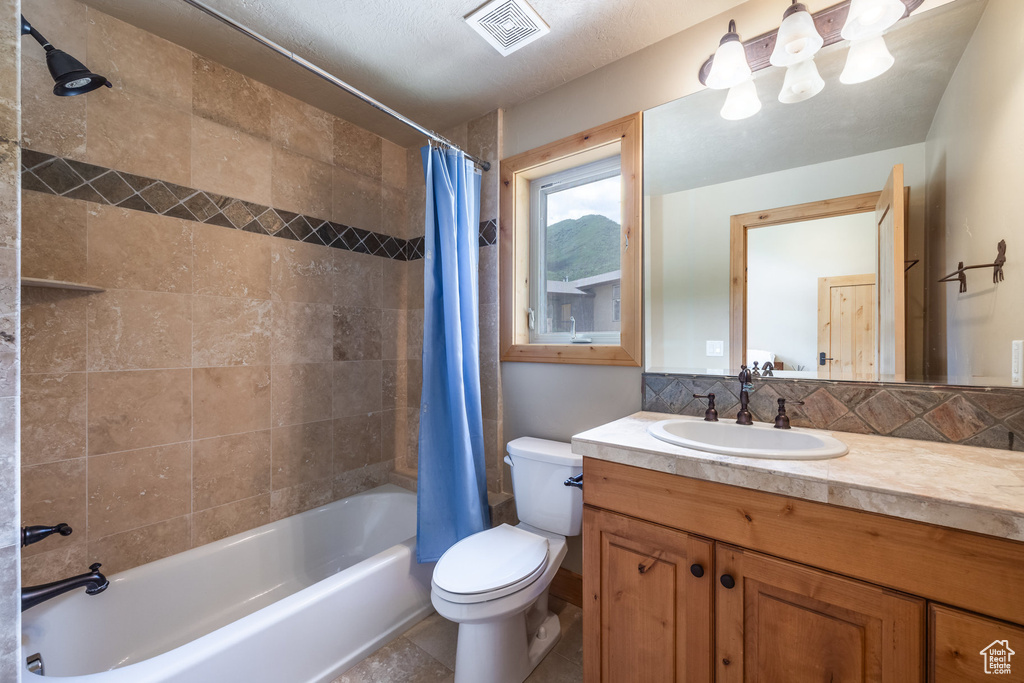 Full bathroom featuring shower / tub combo and vanity