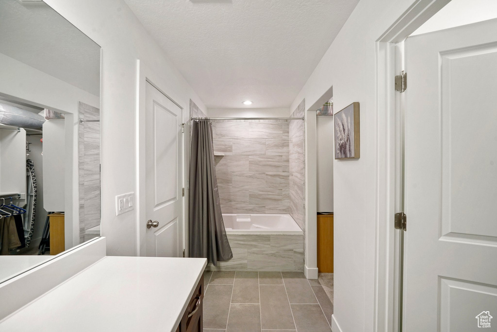Bathroom with vanity, tile patterned flooring, shower / tub combo with curtain, recessed lighting, and a spacious closet