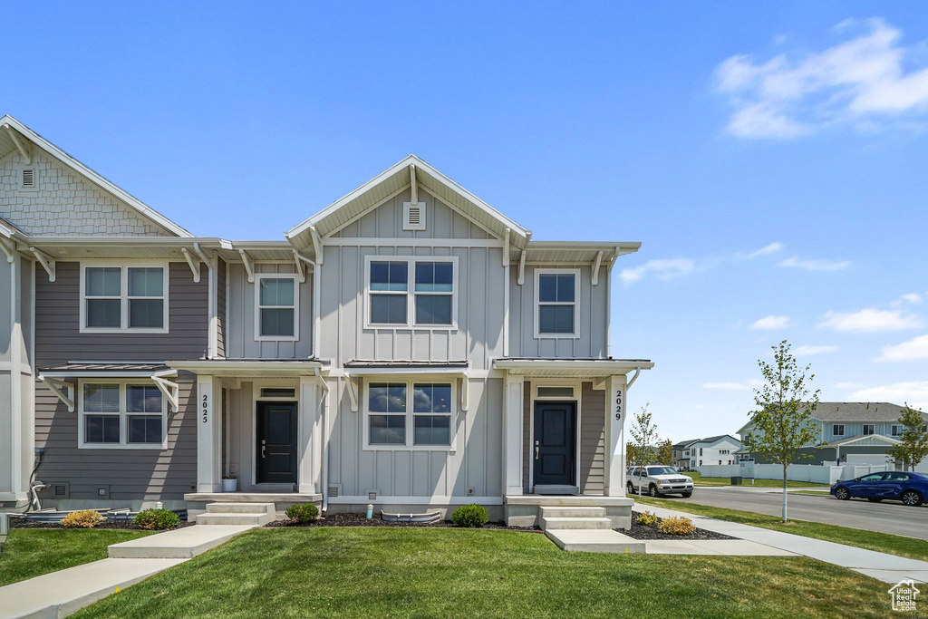 Multi unit property with board and batten siding and a front lawn