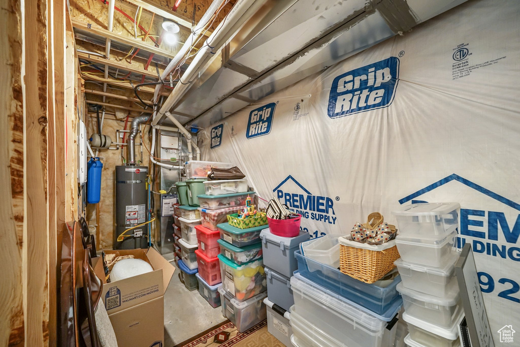 Unfinished basement featuring secured water heater