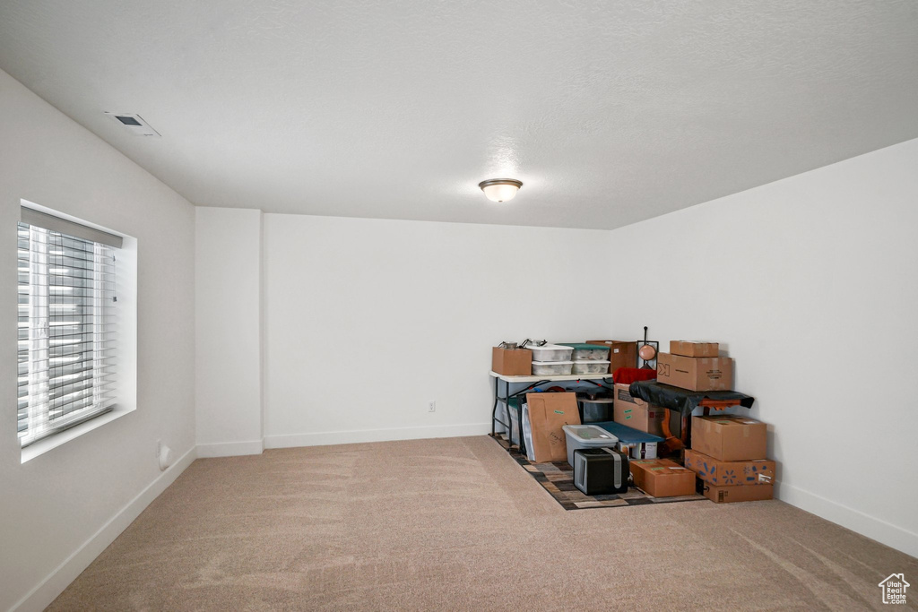 Carpeted empty room featuring baseboards