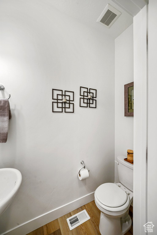 Bathroom with baseboards and wood finished floors
