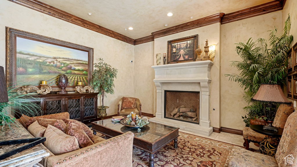 Tiled living area featuring crown molding, a fireplace with raised hearth, and recessed lighting