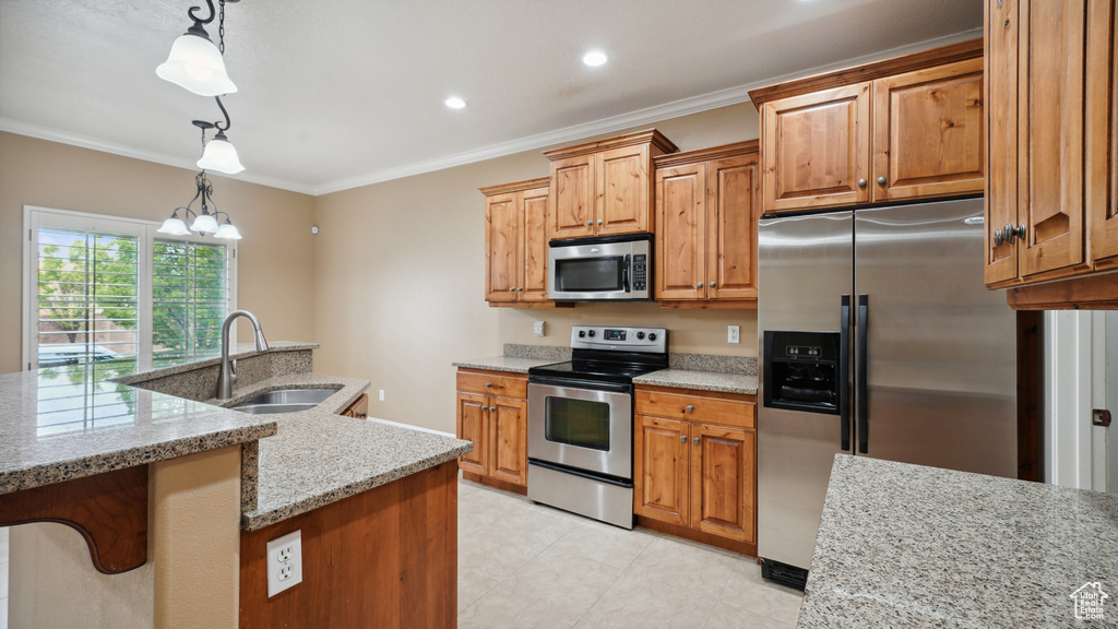 Kitchen featuring appliances with stainless steel finishes, light stone counters, ornamental molding, hanging light fixtures, and a chandelier
