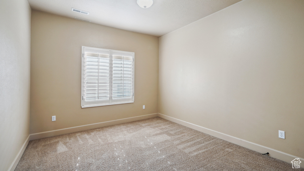 Unfurnished room featuring carpet and baseboards