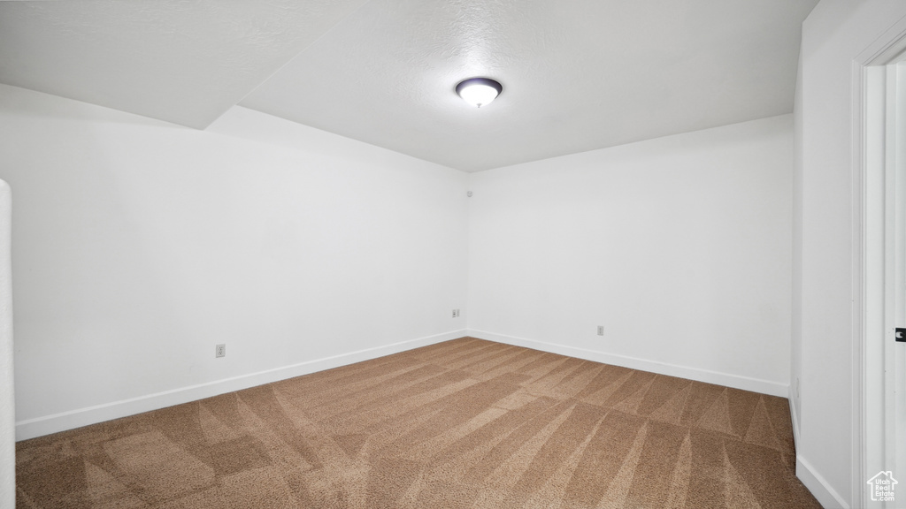 Unfurnished room featuring carpet and baseboards