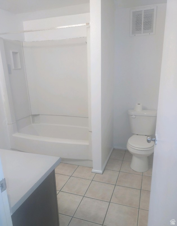 Bathroom featuring tile patterned flooring, vanity, and bathtub / shower combination