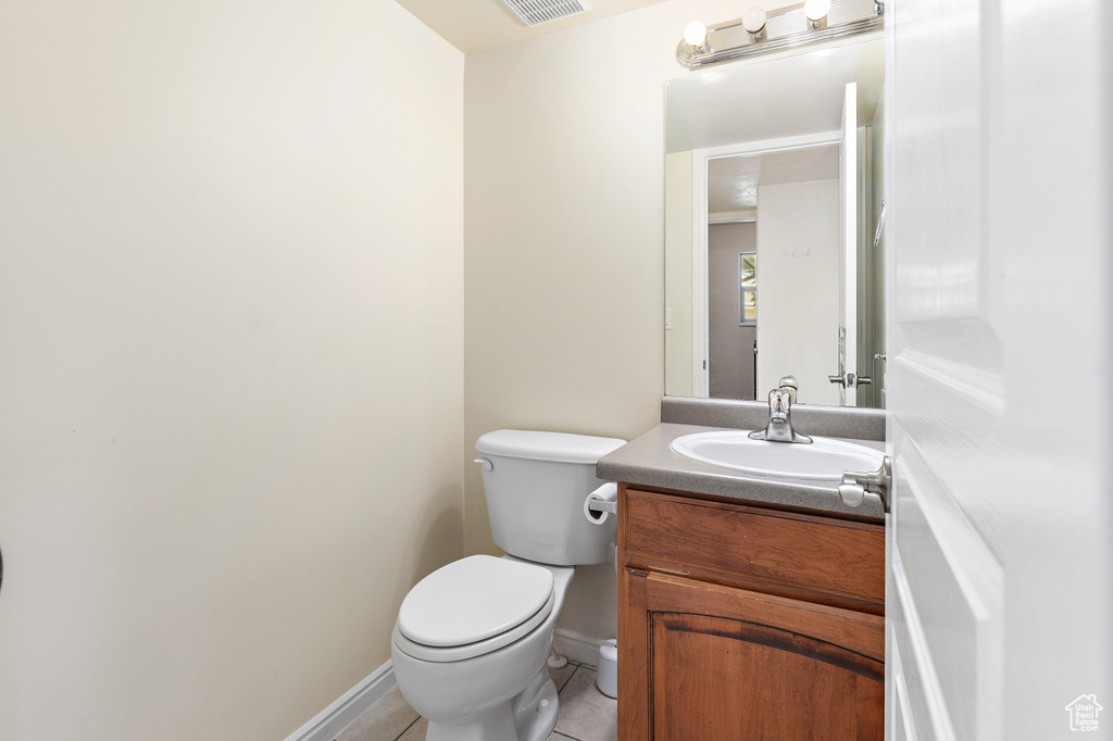 Half bath featuring vanity and tile patterned flooring
