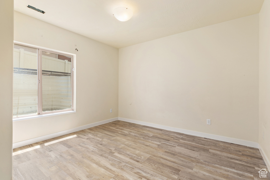 Unfurnished room featuring light wood-style floors and baseboards