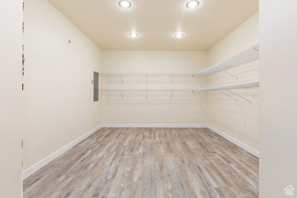 Walk in closet featuring light wood-style flooring and electric panel