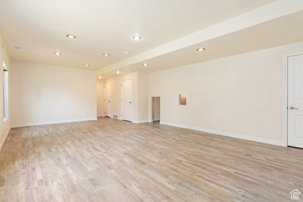 Empty room with recessed lighting and light wood-style floors