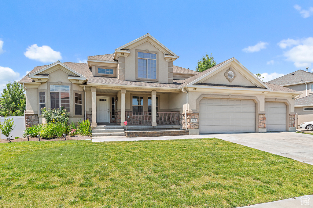 Craftsman inspired home featuring stucco siding, covered porch, driveway, a garage, and stone siding