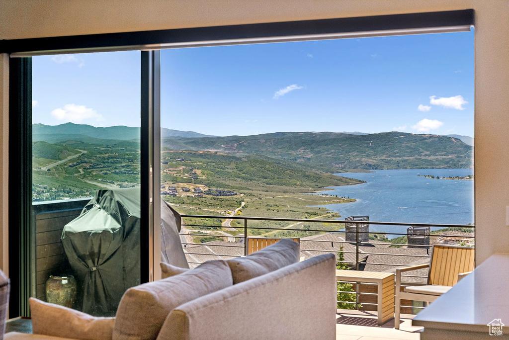 Balcony with a water and mountain view
