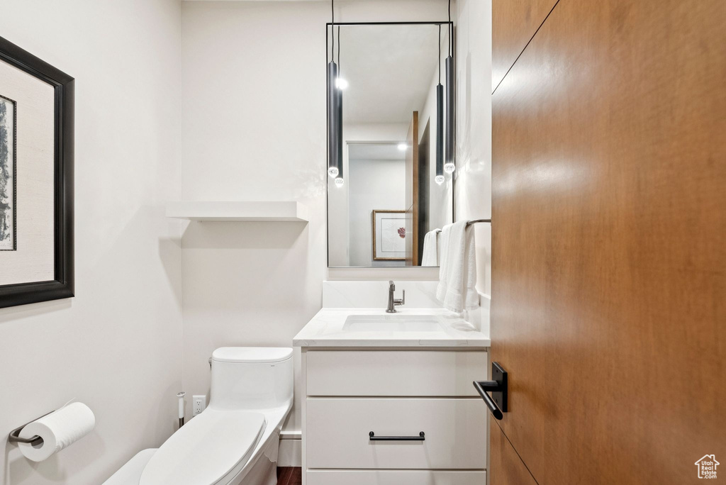 Half bath featuring toilet and vanity