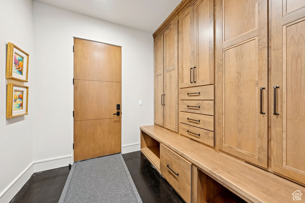 Mudroom with baseboards and concrete floors