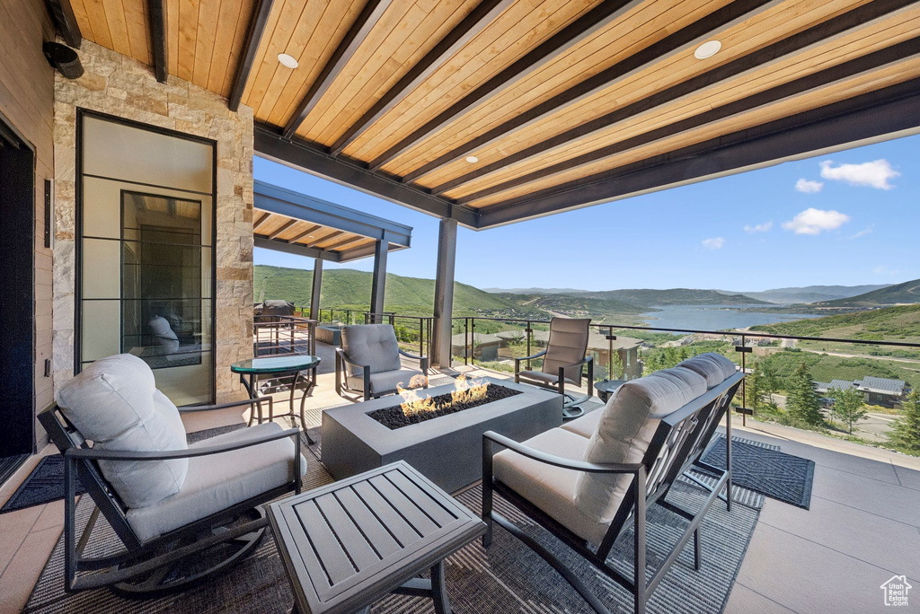 View of patio with a fire pit and a mountain view