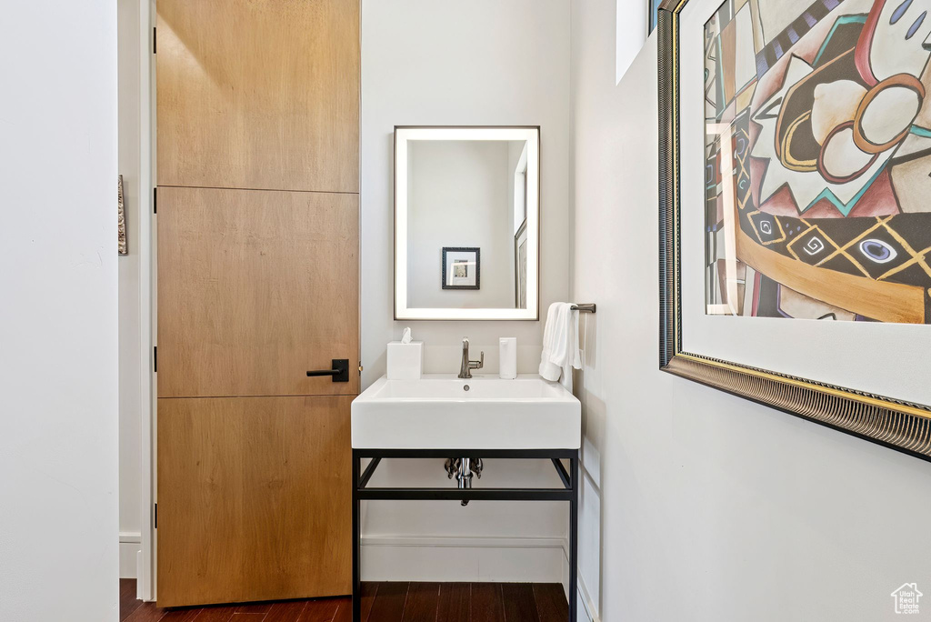 Bathroom featuring a sink and wood finished floors