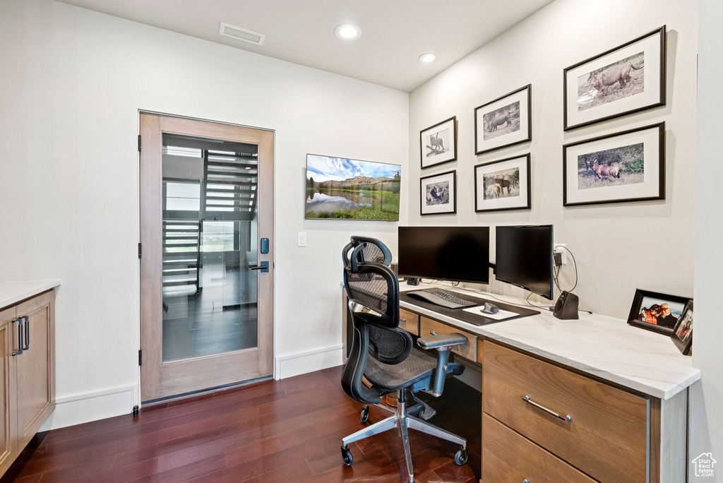 Office area featuring dark wood-style flooring and recessed lighting