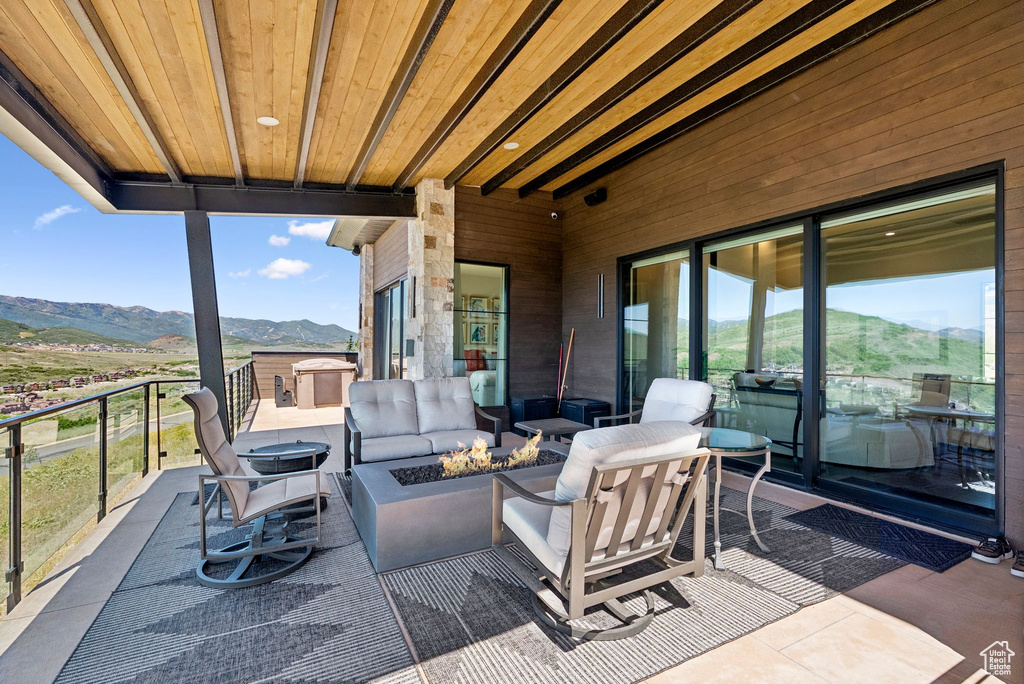 Patio / terrace with a mountain view and an outdoor living space with a fire pit