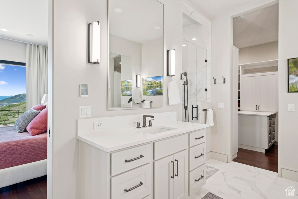 Bathroom with ensuite bath, vanity, a shower stall, recessed lighting, and marble finish floors
