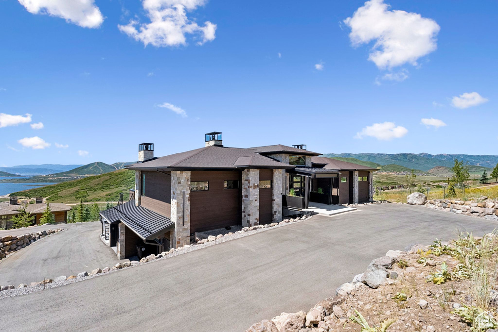 View of front of house featuring a mountain view and a chimney