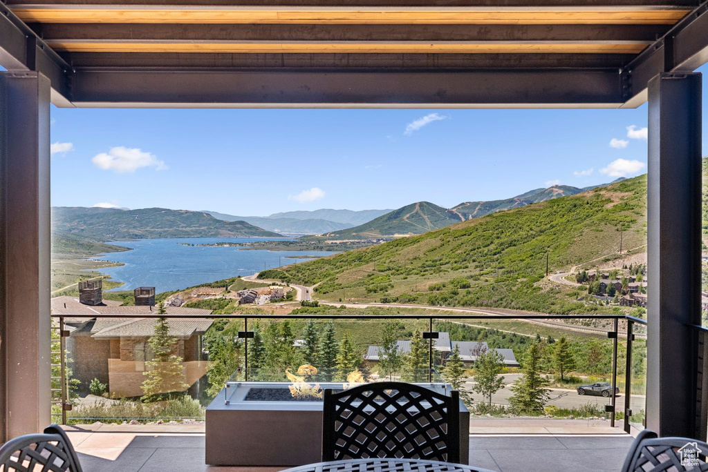 Balcony with a water and mountain view