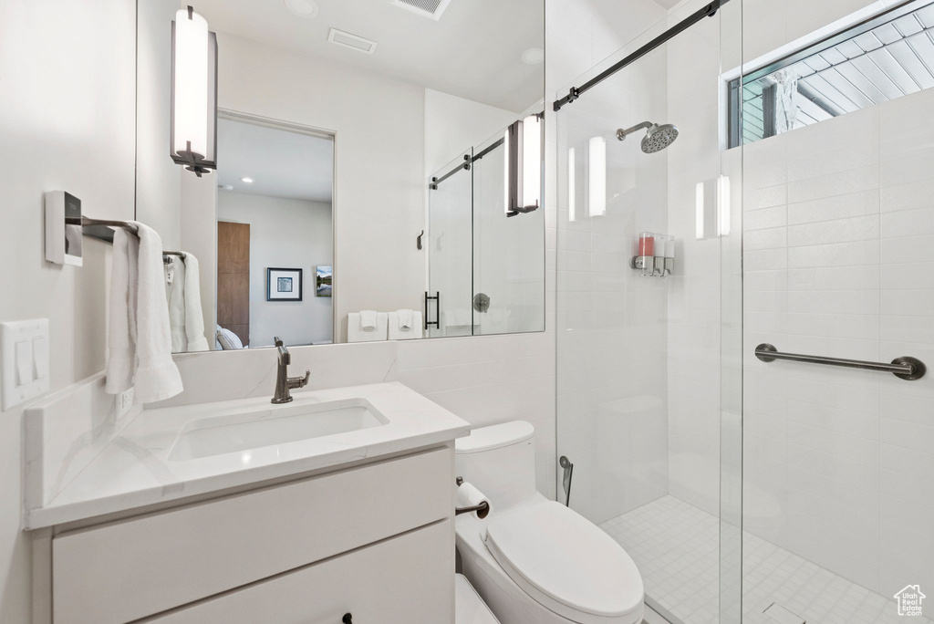Ensuite bathroom with vanity and a shower stall