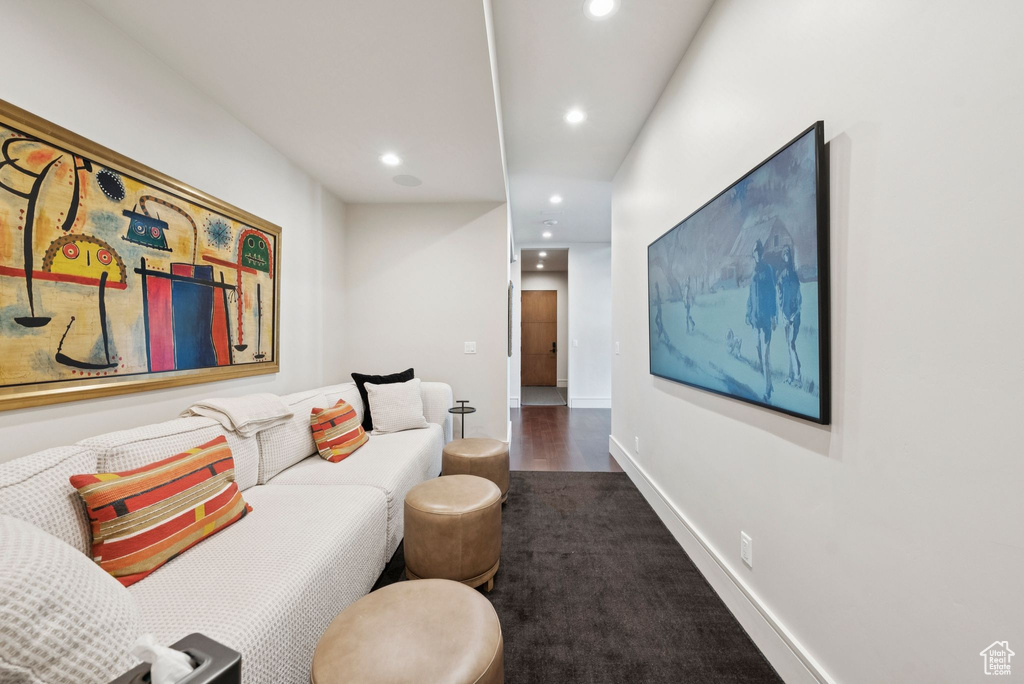 Carpeted living area with recessed lighting