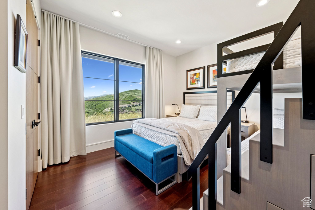 Bedroom with dark wood-style floors and recessed lighting