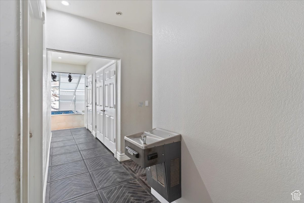 Hall with dark tile patterned floors