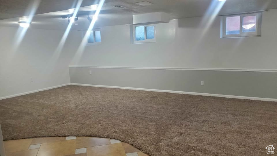 Basement with carpet and baseboards